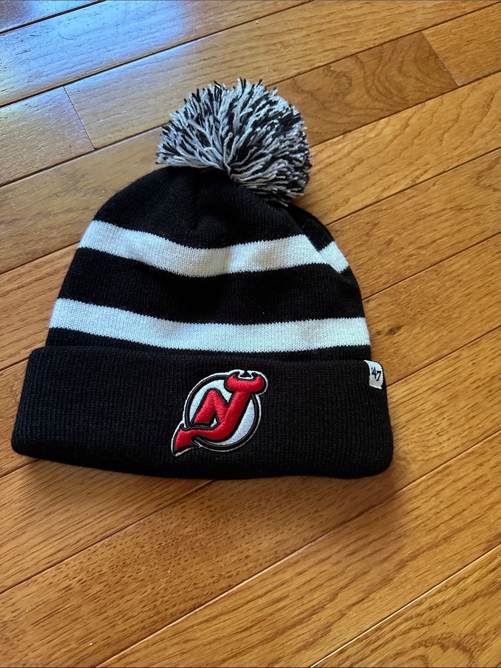 Black & White Striped Pom Beanie with Red Logo